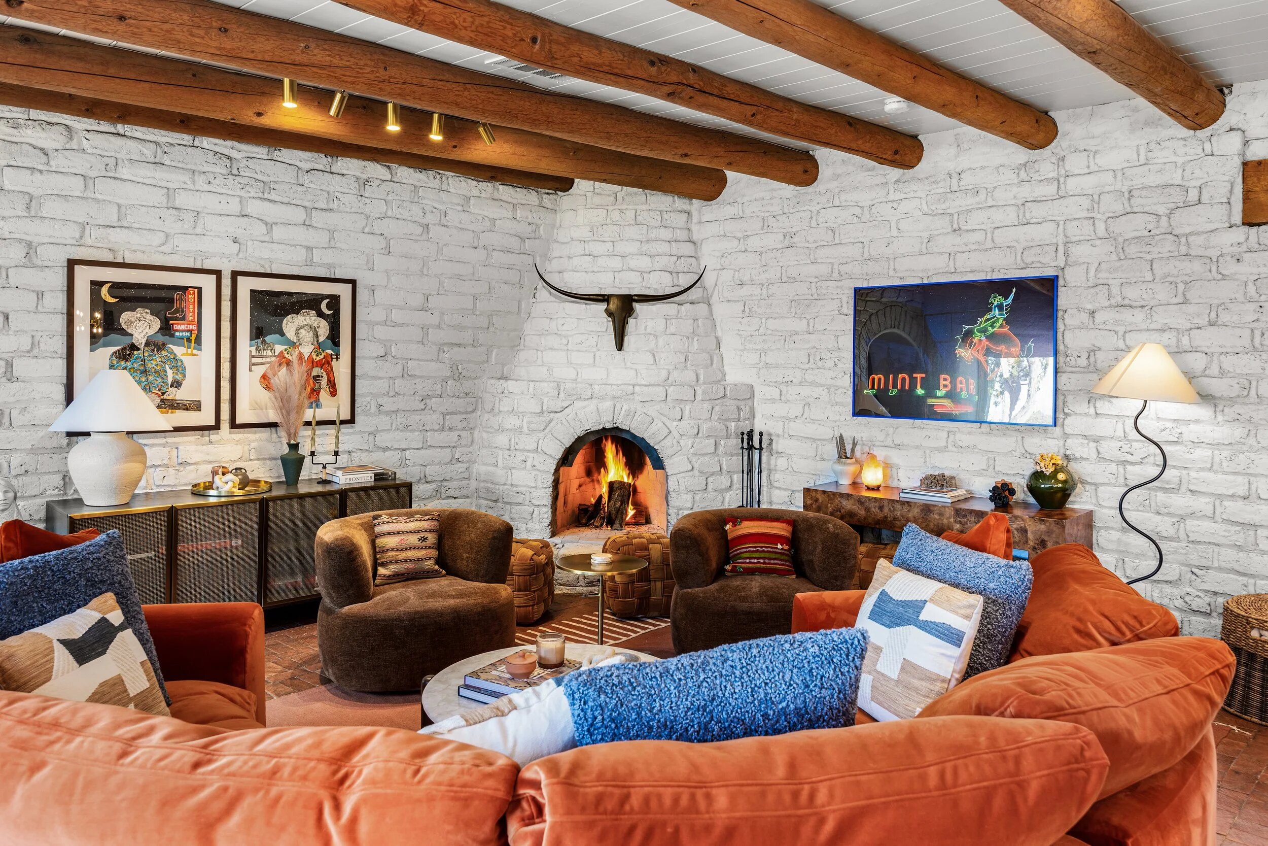 Casa de Ice living room with kiva fireplace and exposed vigas